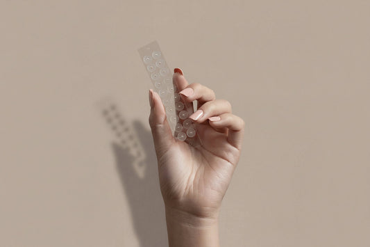 Female hand holding 20 ear seeds on transparent film