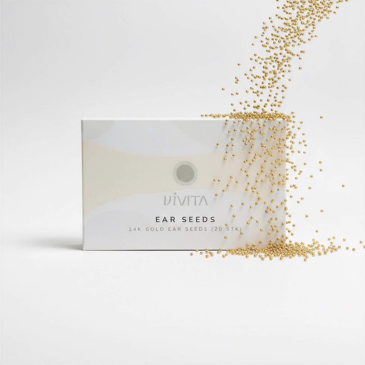 Creative image of gold beads falling on vivita box 