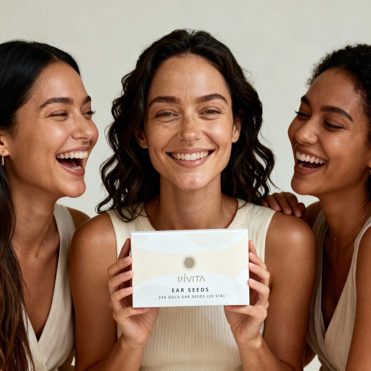 Three woman together, one holding Vivita Ear Seeds box
