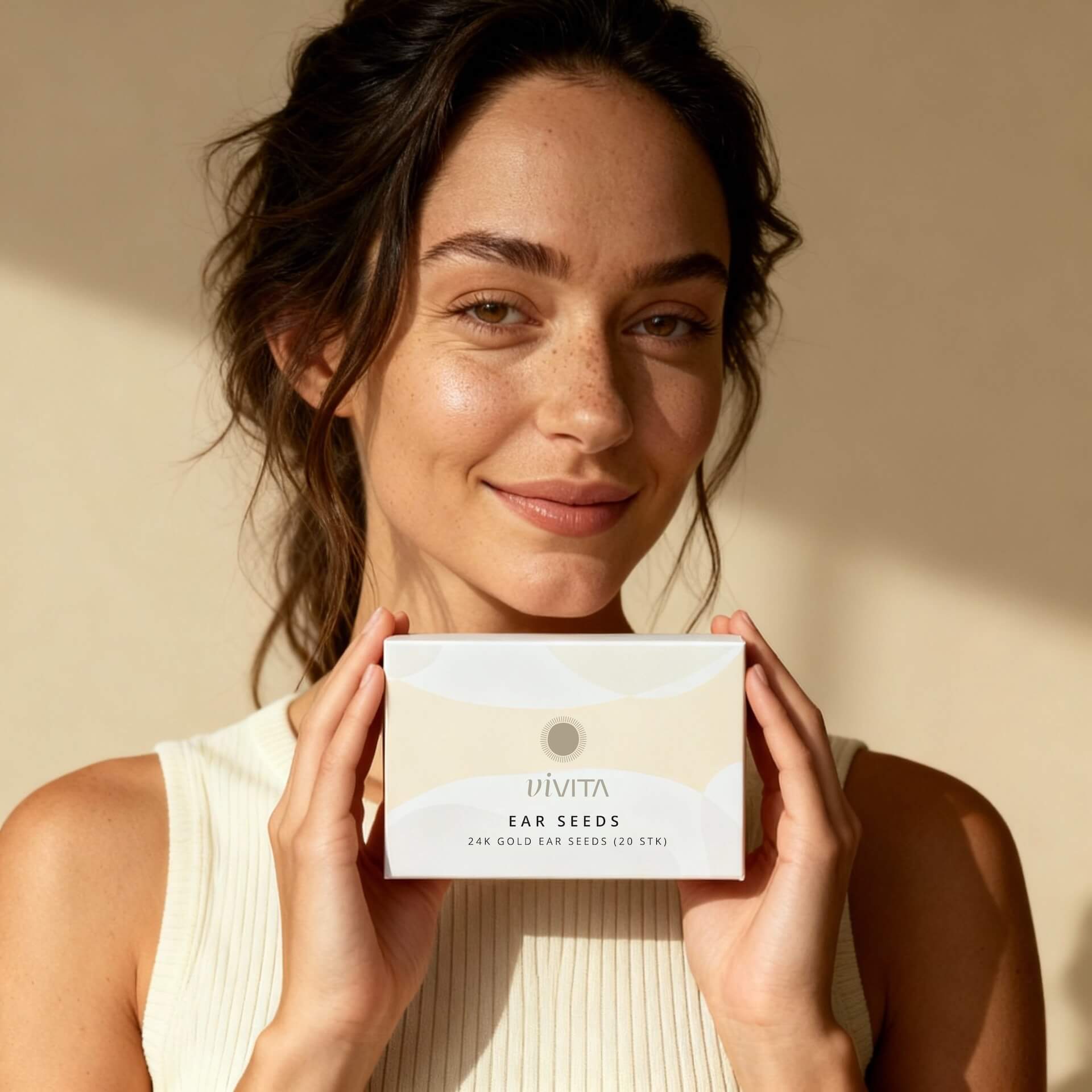 Woman holding Vivita Ear Seeds box