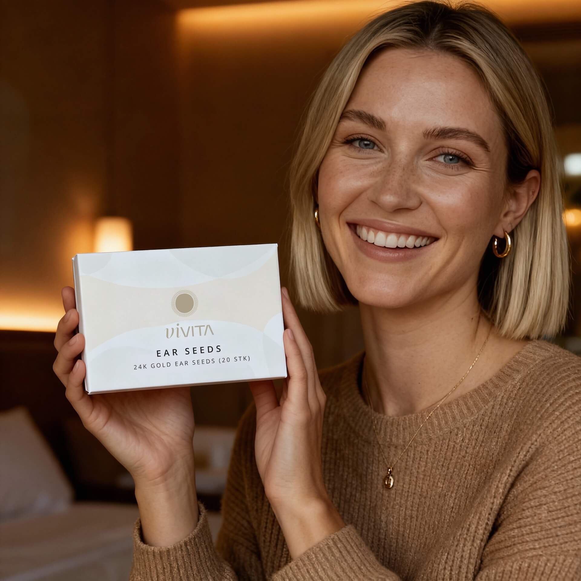 Woman holding Vivita Ear Seeds box