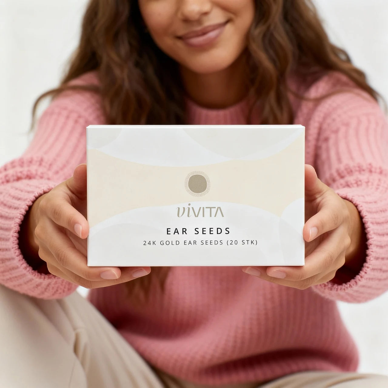 Model holding Vivita box into camera